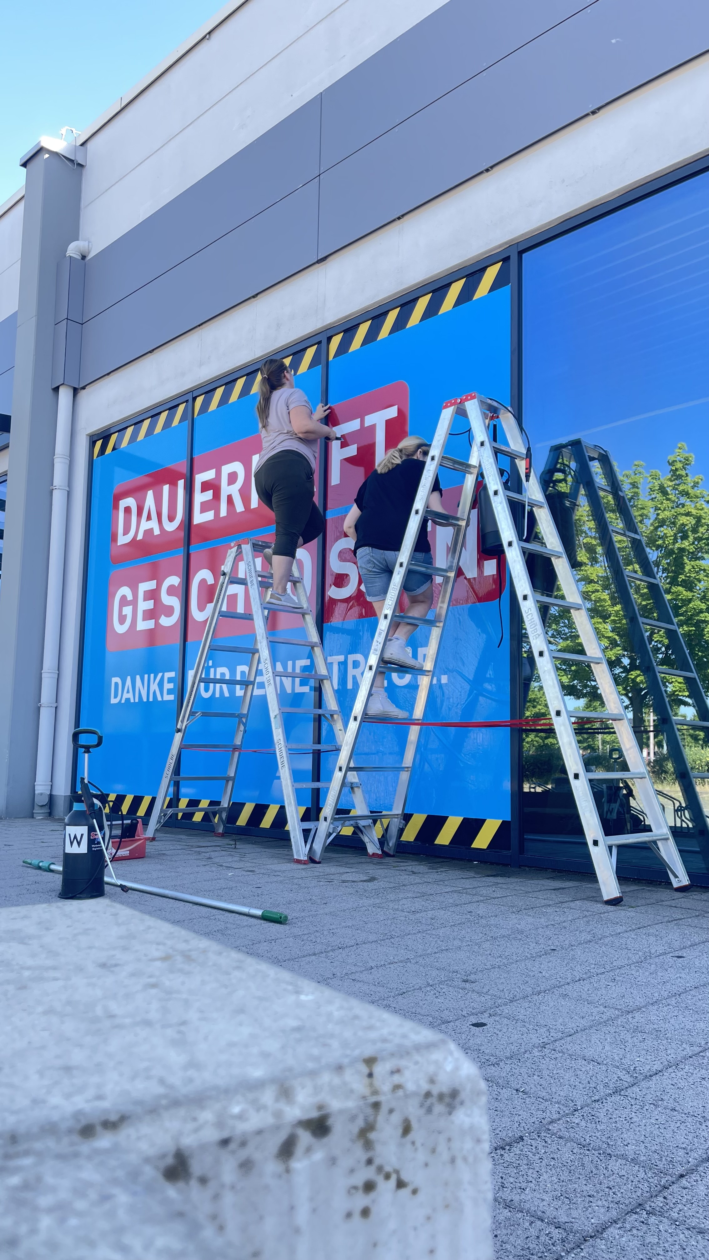 Werbetechnik – Team bei der Montage eines Fensterplotts